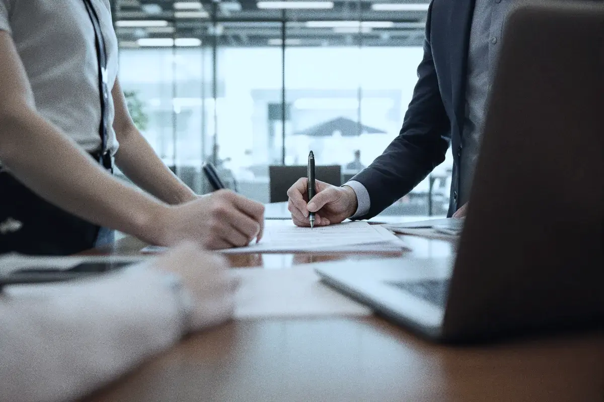 Colleagues reviewing documents together around a boardroom table